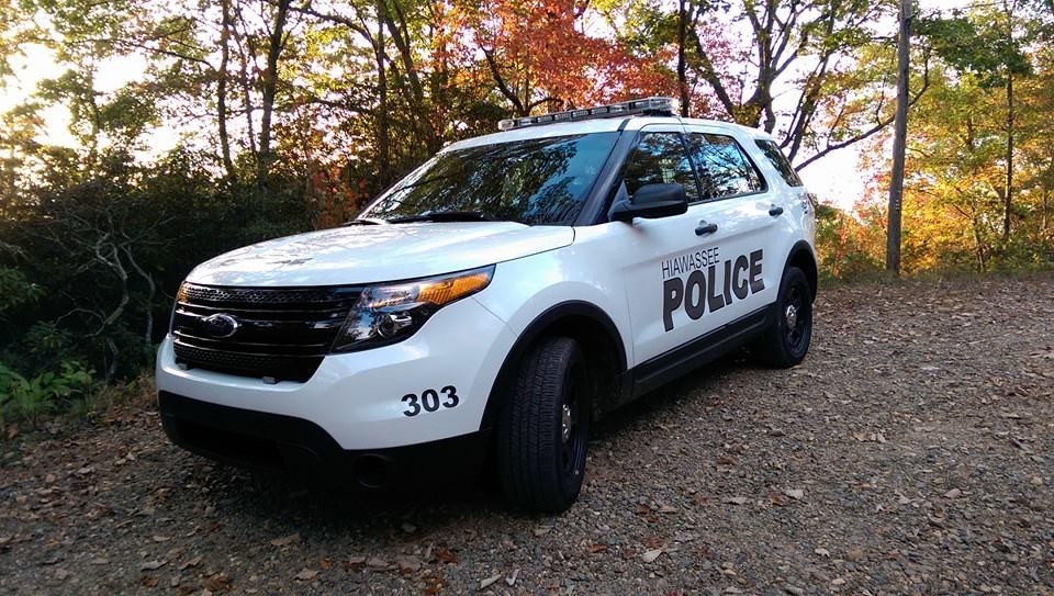 A Hiawassee Police patrol vehicle, unit 303, on a gravel road in autumn.